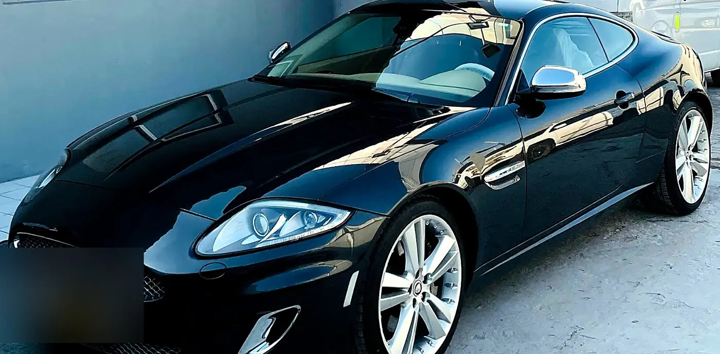 The same Jaguar XKR after repair and repaint in gloss black